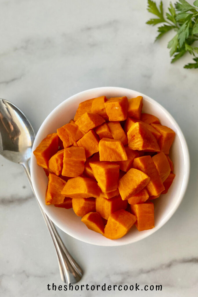 Instant Pot Cubed Sweet Potatoes ready to eat in a bowl with a spoon