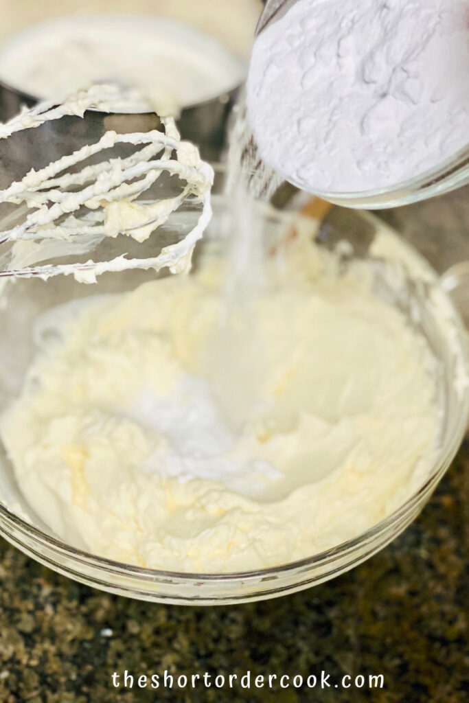 Keto No-Bake Cheesecake adding powdered monkfruit sweetener to whipped cream cheese mix