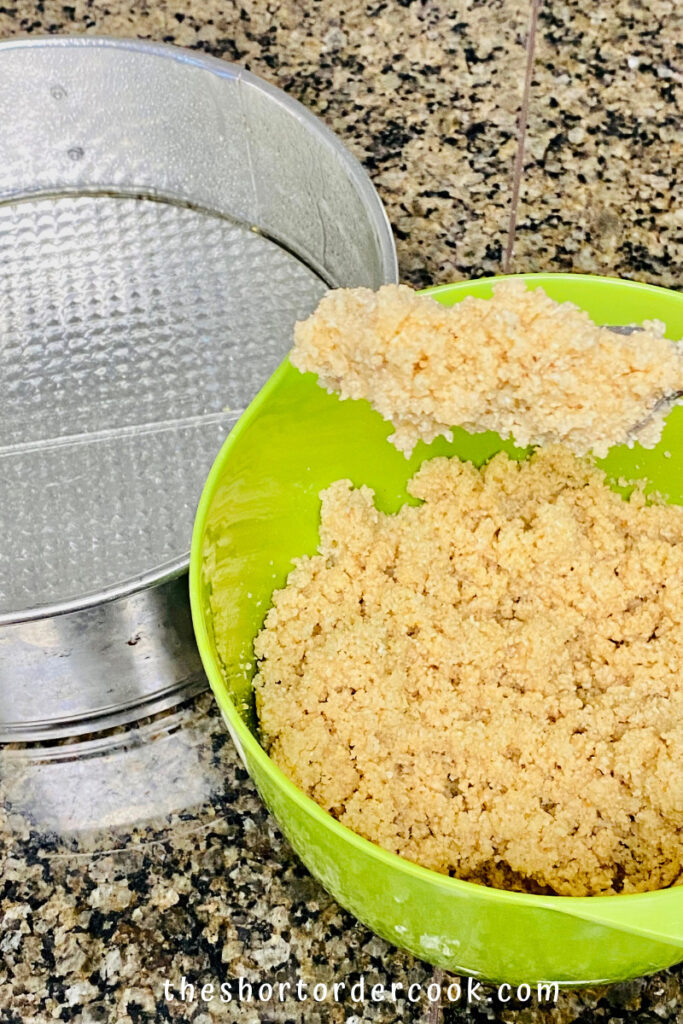 The crust texture shown in the bowl made from almond flour and the prepared springform pan for the cheesecake recipe.