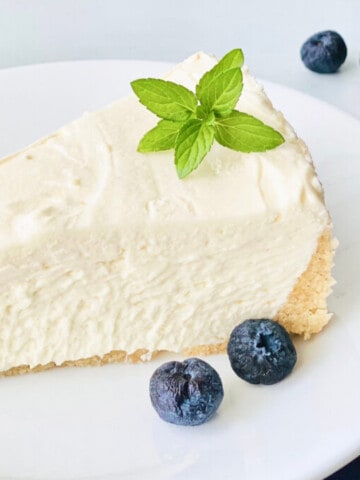 Keto No-Bake Cheesecake featured closeup slice of cheesecake with blueberries