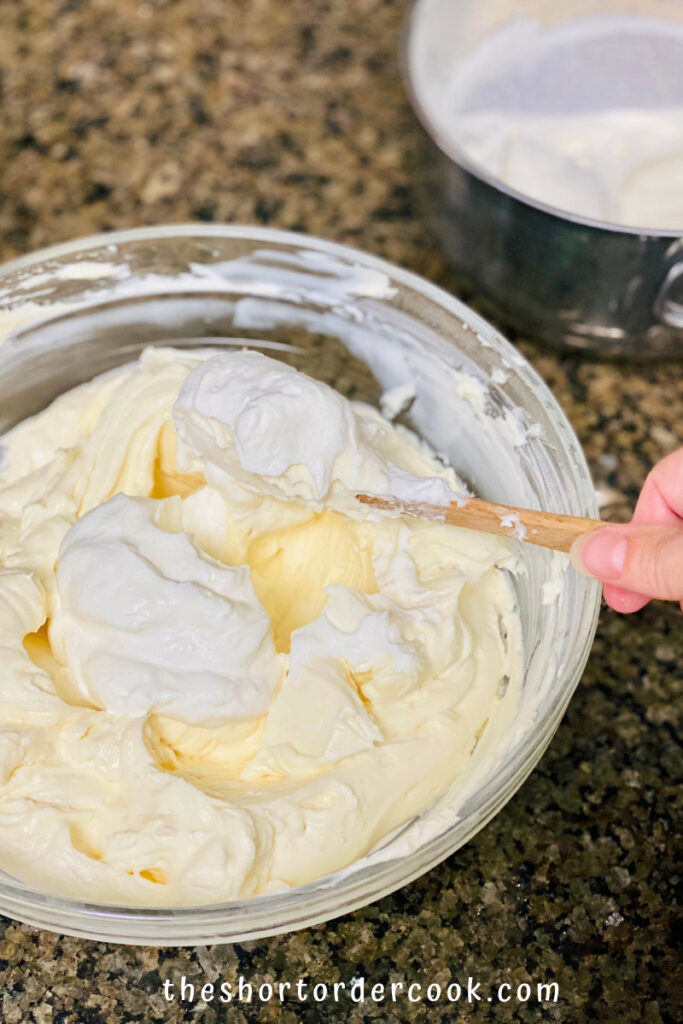 Keto No-Bake Cheesecake folding whipped cream into cream cheese mixture