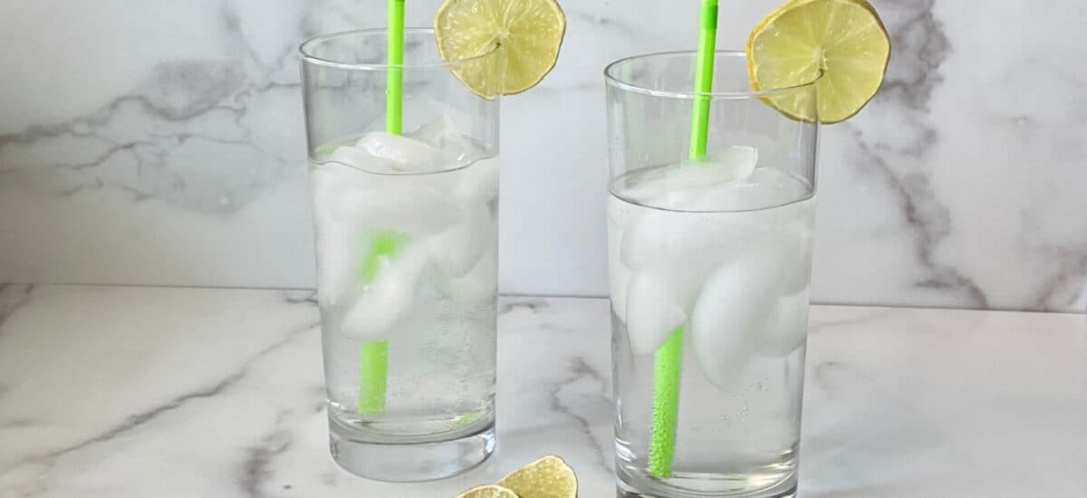Texas Ranch Water featured 2 glasses ready to drink with green straws and lime slices