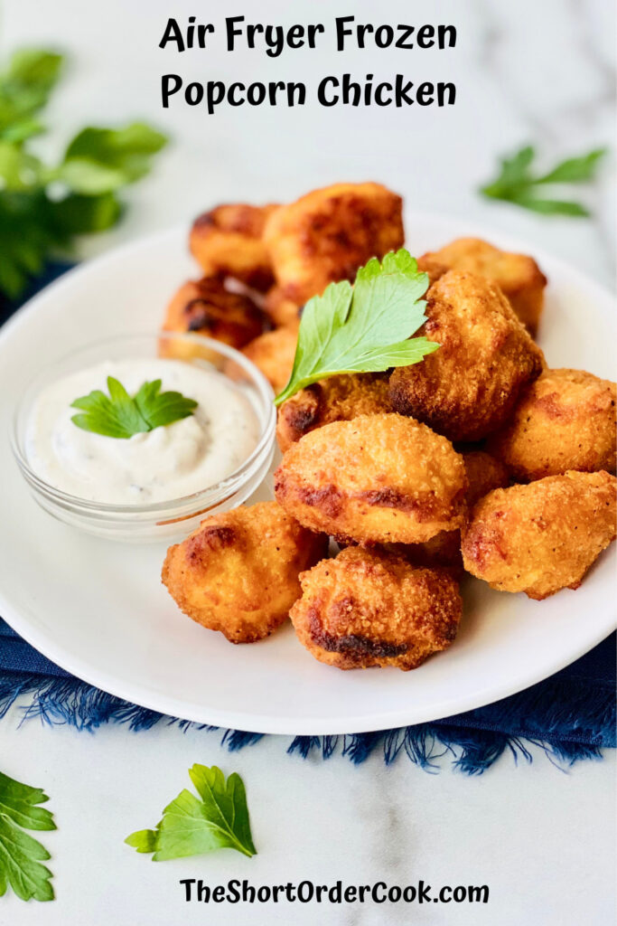 Air Fryer Frozen Popcorn Chicken plated with parsley and ranch dip