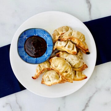 Air Fryer Frozen Potstickers featured plated with soy dipping sauce