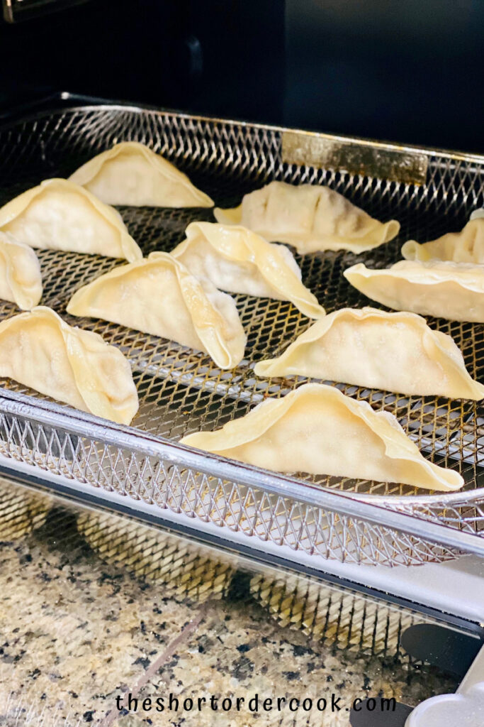 Air Fryer Frozen Potstickers on the tray frozen to put into the air fryer