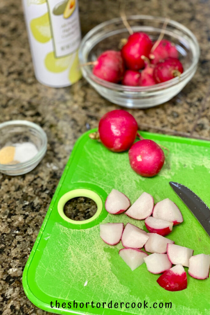 Crispy Air Fryer Keto Radishes cutting board with cut & whole radishes small bowl with spices and full bowl of radishes