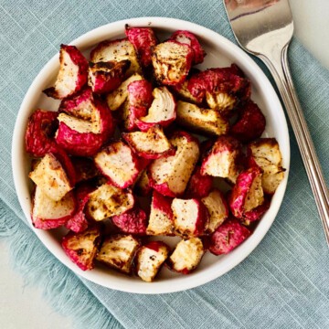 Crispy Air Fryer Keto Radishes featured recipe card image overhead of round plate with radishes ready to eat napkin and fork