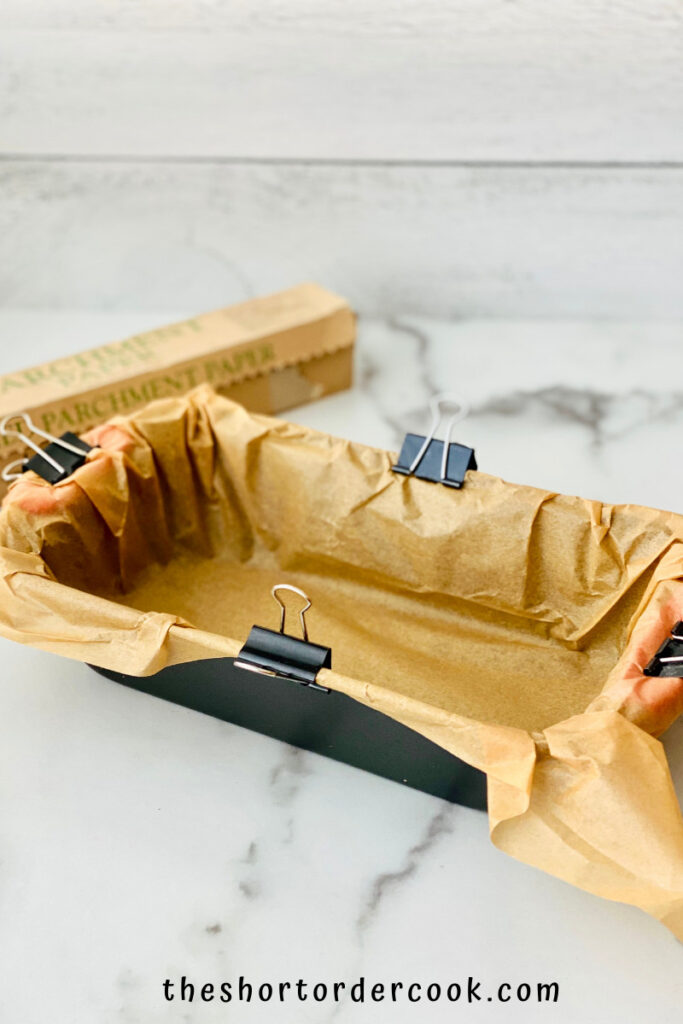 Easy Old-Fashioned Peanut Butter Fudge prep loaf pan with parchment paper held with binder clips