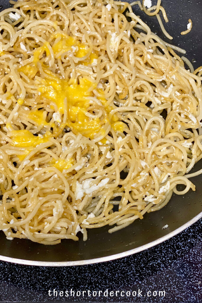 Fried Spaghetti with Eggs egg yolks slowly added to the skillet with spaghetti