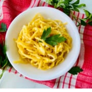 Fried Spaghetti with Eggs recipe card bowl ready to eat topped with fresh parsley