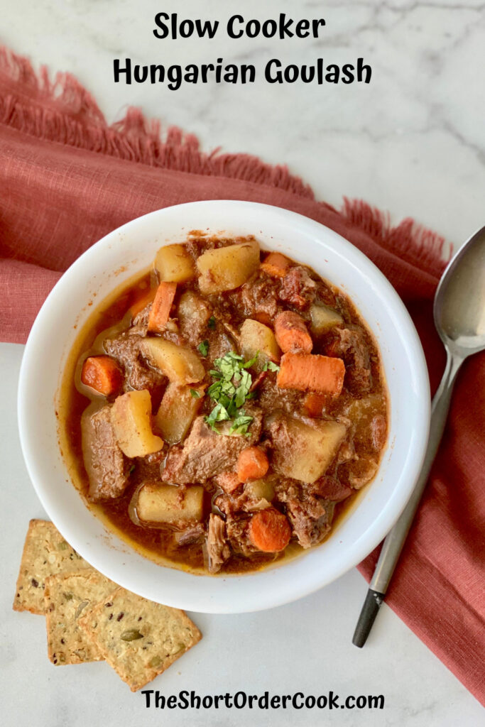 Slow Cooker Hungarian Goulash PN1 bowl filled ready to eat with crackers spoon napkin