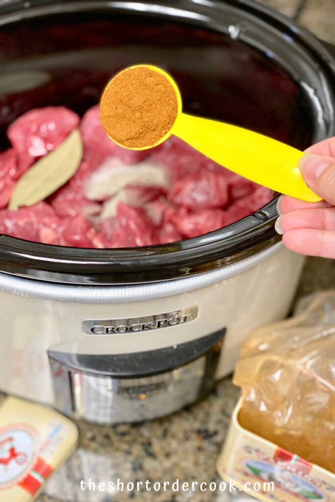 Slow Cooker Hungarian Goulash meat in the CrockPot and adding the paprika