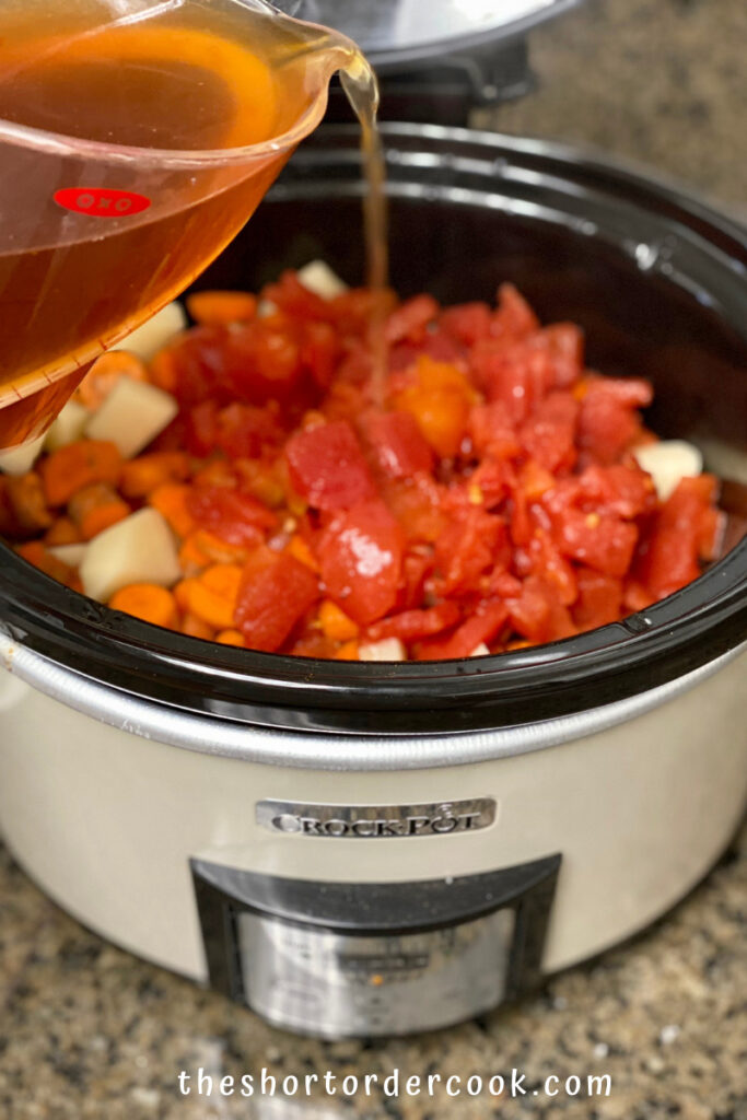 Slow Cooker Hungarian Goulash tomatoes and broth being added
