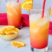 Vodka Sunrise featured two glasses and oranges slices and half