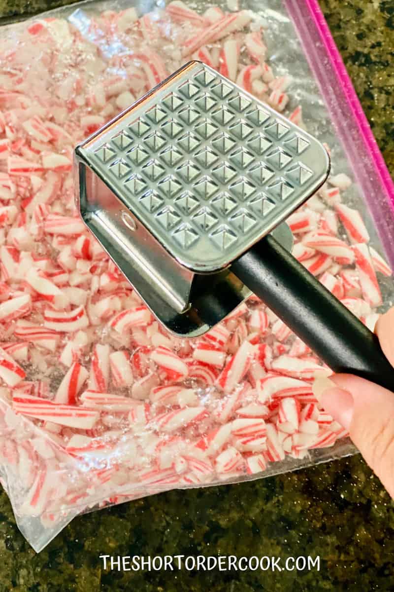 2-Ingredient Peppermint Bark smashing candy canes in the Ziploc bag