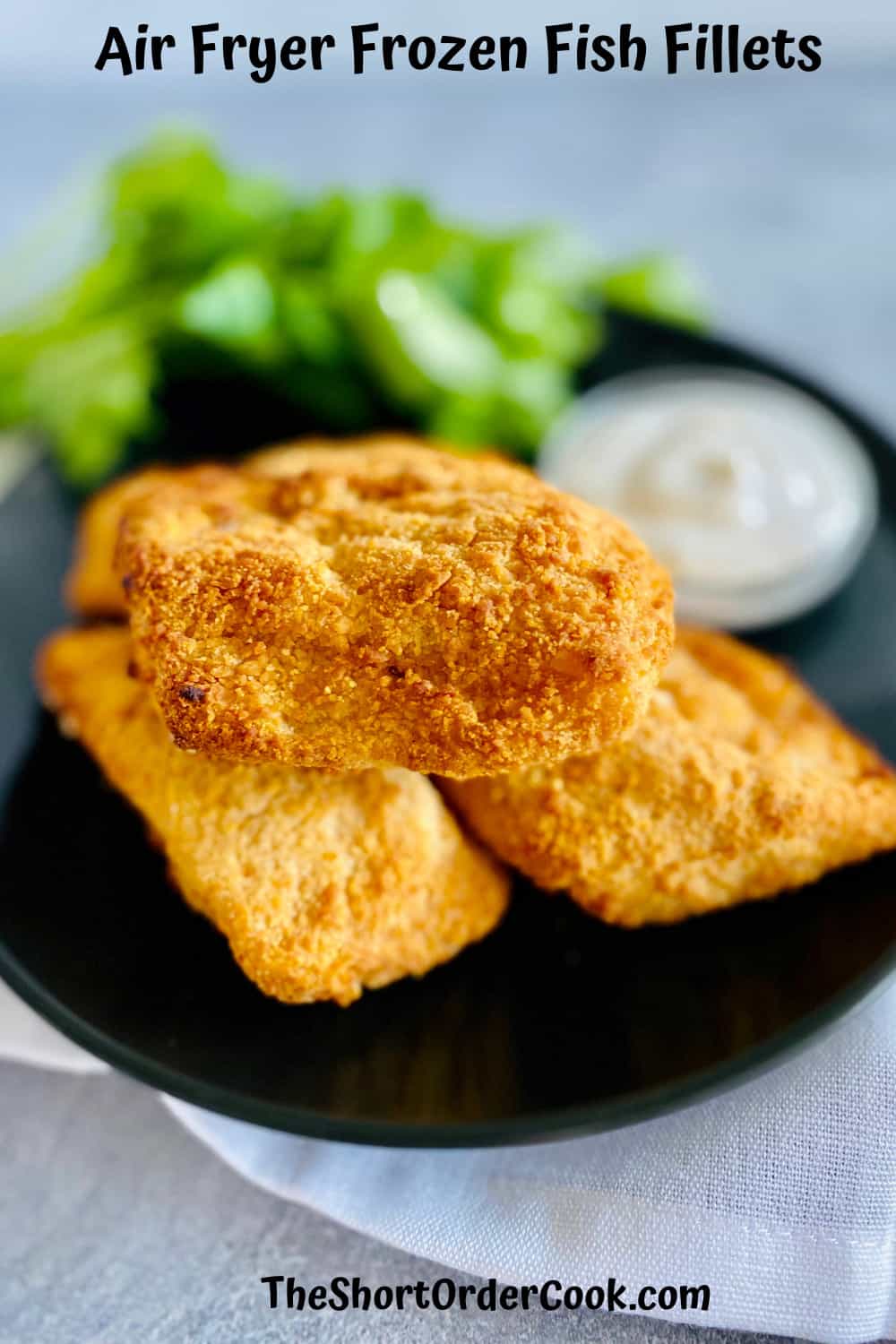 plated cooked fish fillets stacked on a plate with a ranch dipping sauce