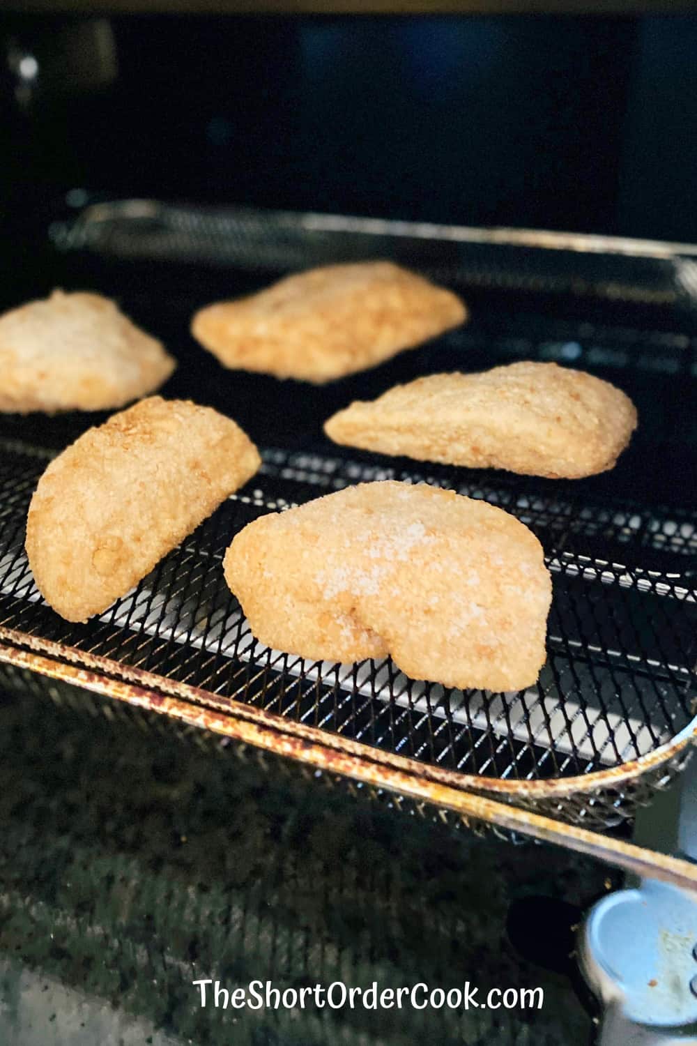 5 pieces of breaded fish on the air fryer tray
