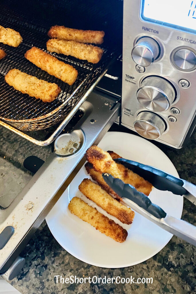 Fish Sticks removing them from the air fryer oven