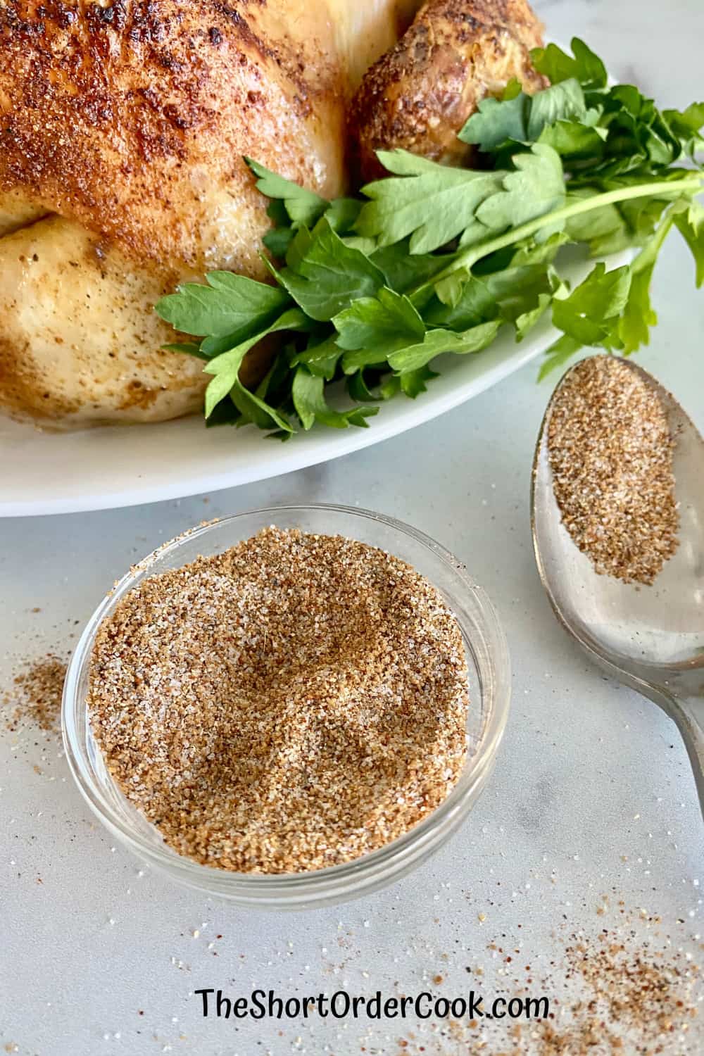 Easy Dry Rub for Whole Chicken (Smoked or Baked) closeup bowl spoon and chicken ready to eat.
