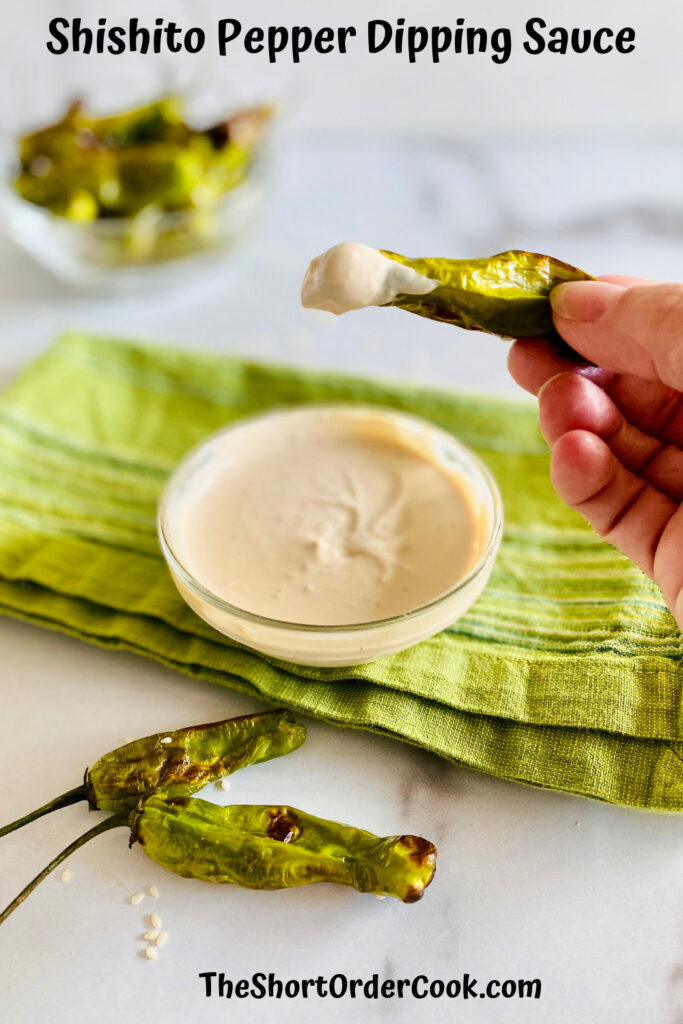 dipping into the bowl of creamy sweet & salty dipping sauce with a shishito pepper