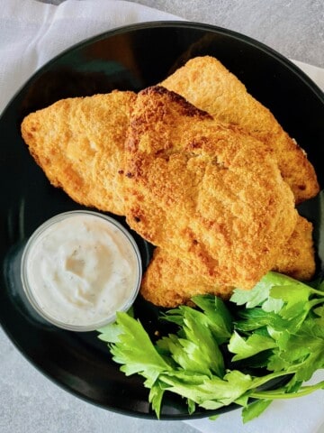 plated crispy brown fish fillets with ranch dipping sauce