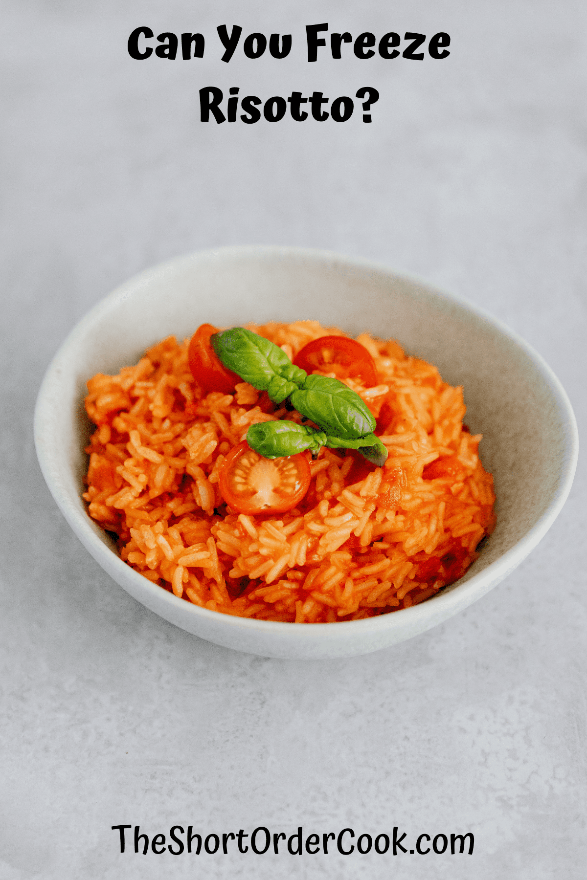 tomato sauce risotto in a bowl topped with fresh basil