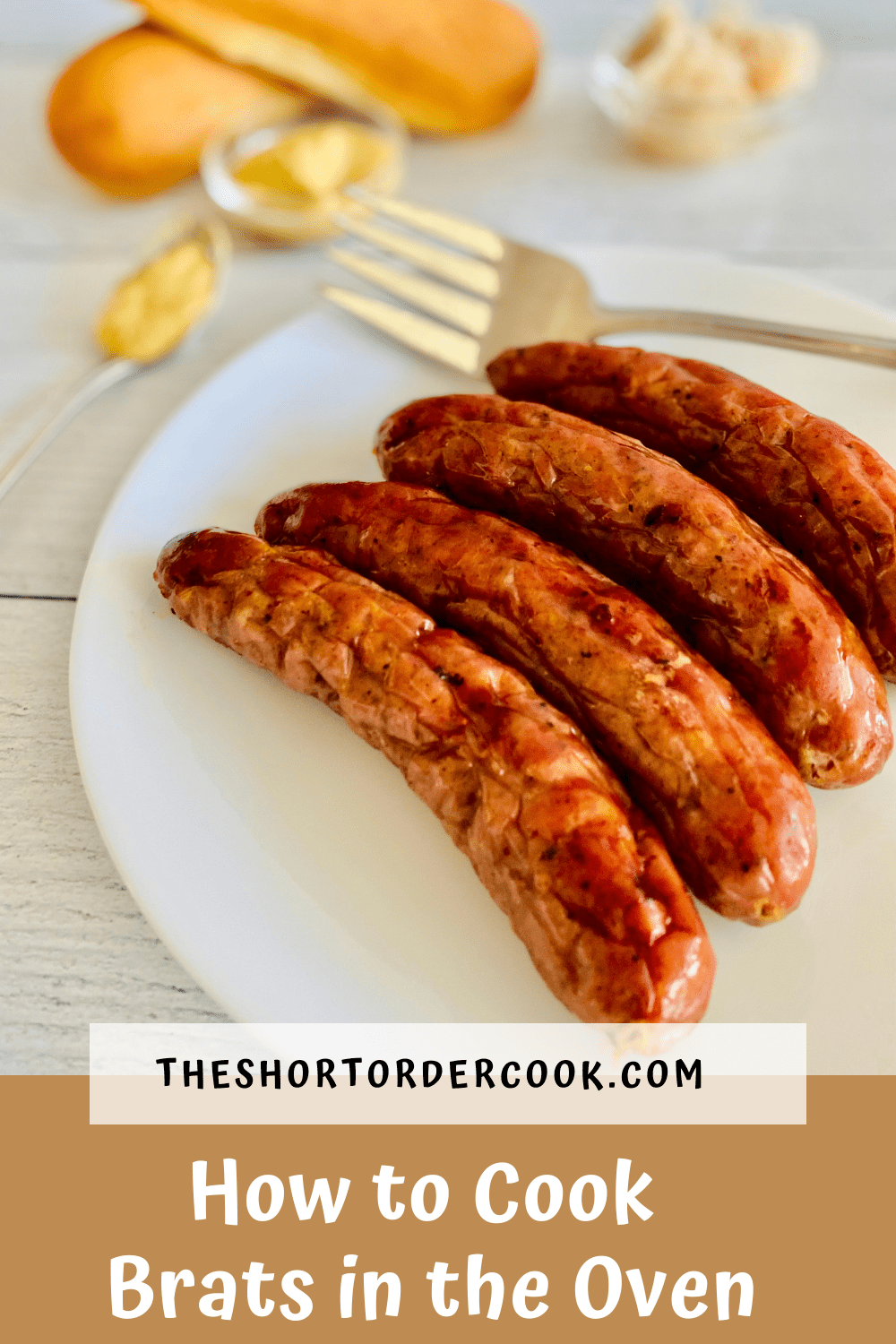 4 oven cooked bratwurst links ready to eat with buns, mustard, and sauerkraut on the table