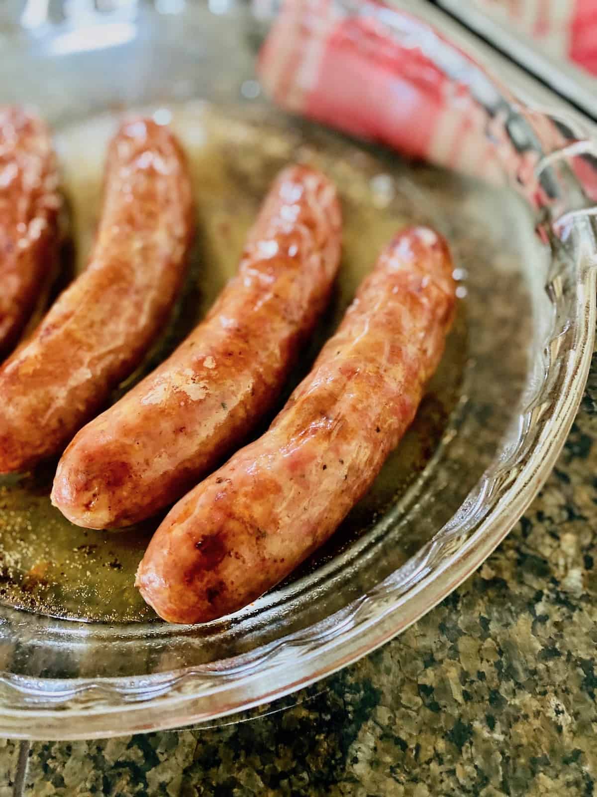 brats are brown and done baking in the glass dish