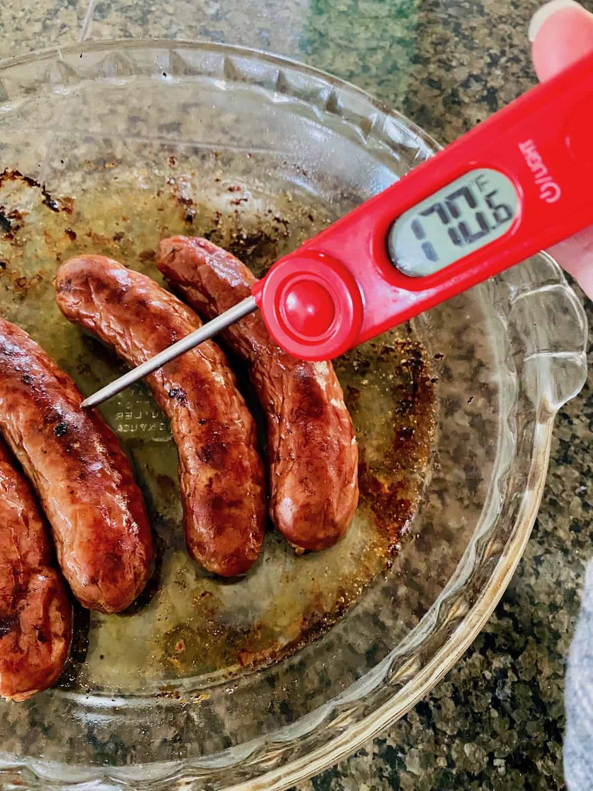 testing broiled brats with meat thermometer reading 170