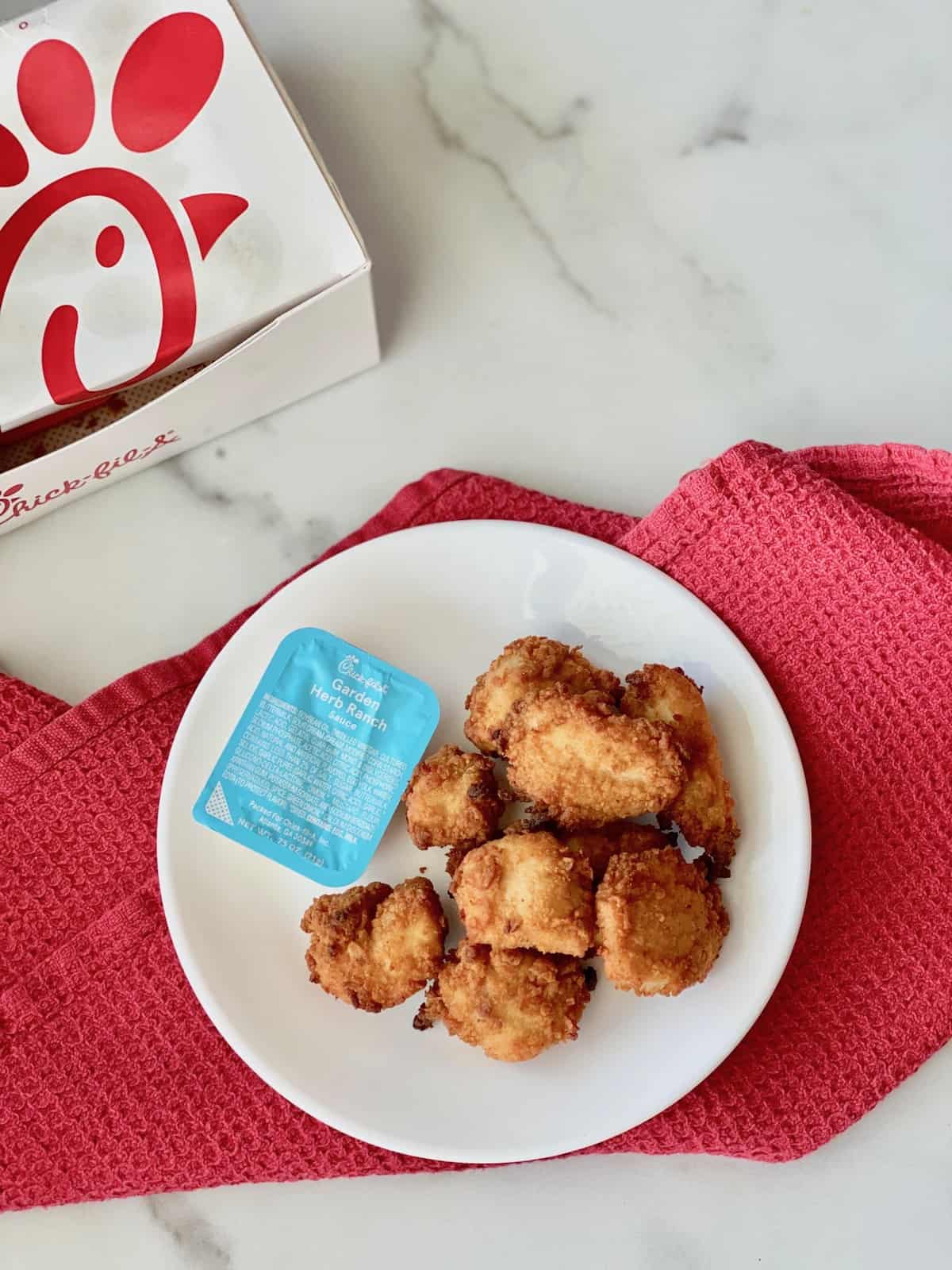 How to Reheat Chick-fil-a Nuggets in the Air Fryer with takeout box and plated ready to eat