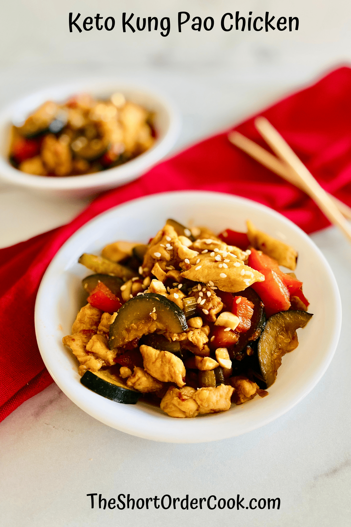Keto Kung Pao Chicken in two white bowls ready to eat with chopsticks