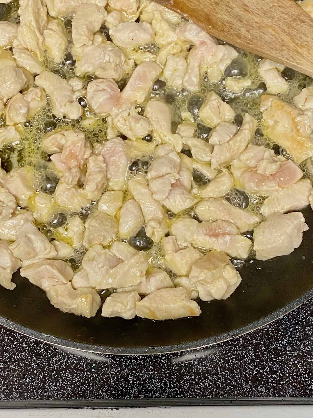 chicken cooking in the saute pan