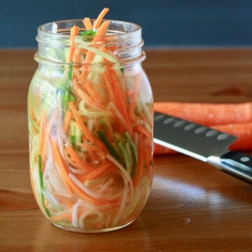 mason jar filled with bright pickled vegetables