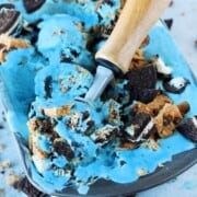 cookie monster blue ice cream in a container with a scoop