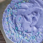 blue cheesecake topped with blue and pink candy jewels
