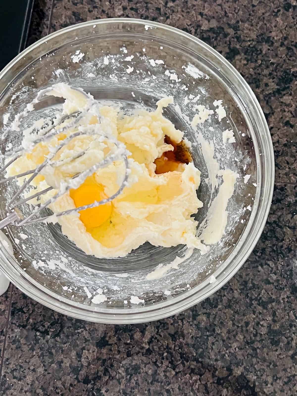 Egg and vanilla added to creamed butter and sugar.