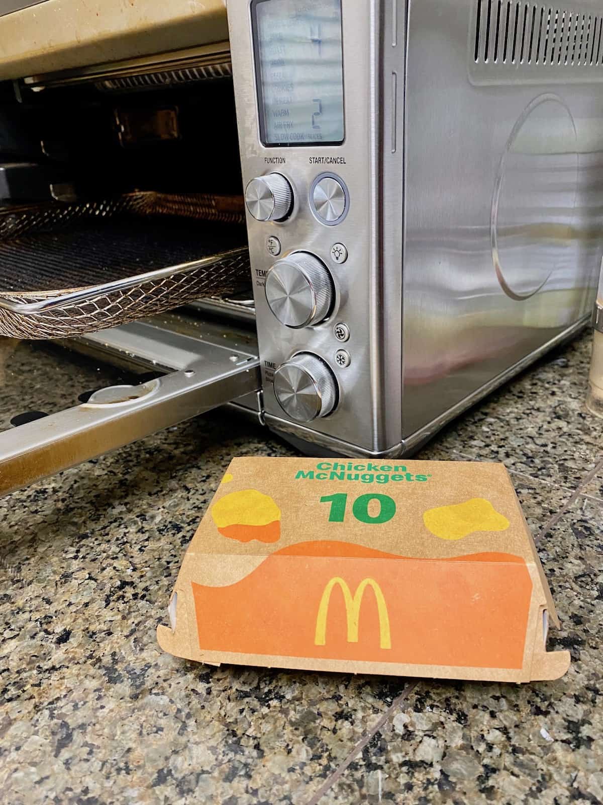 Box of nuggets in front of the air fryer machine.