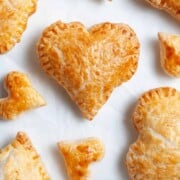 Heart shaped pastries on a table ready to eat.