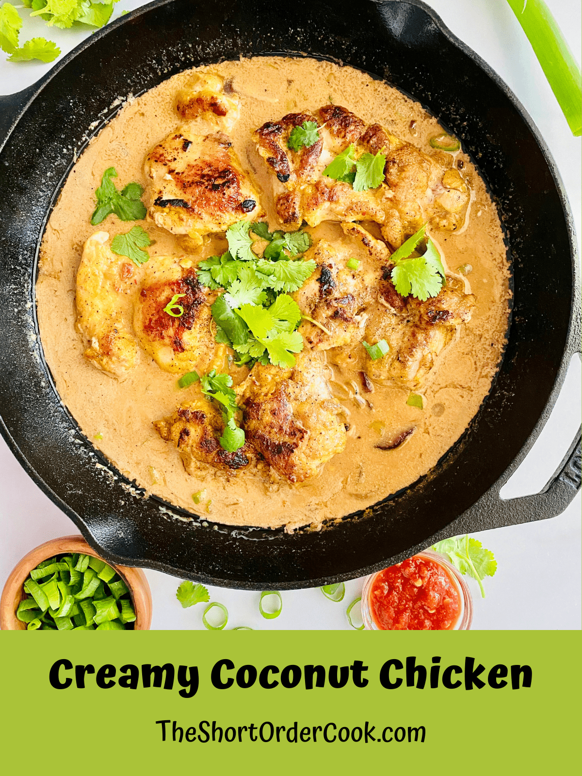 Cast Iron skillet with Creamy Coconut Chicken topped with cilantro and ready to serve.