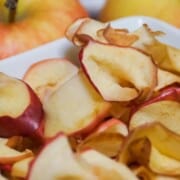 A pile of air fried apple slices in a bowl.