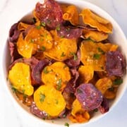 Colorful sweet potato sliced thin into chips and ready to eat.