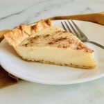 A slice of sugar cream pie (Hoosier pie) on a plate.