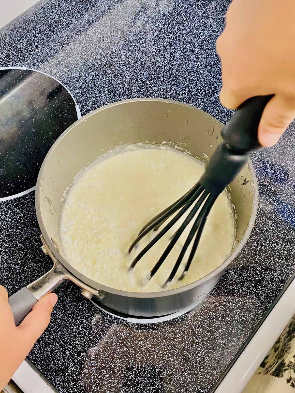 Whisking the half and half into the cornstarch and sugar in a saucepan.