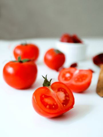 Sliced tomatoes on a white table. 