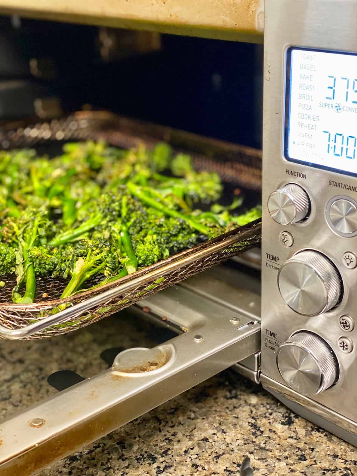 Broccoli on the air fryer tray crispy and cooked.