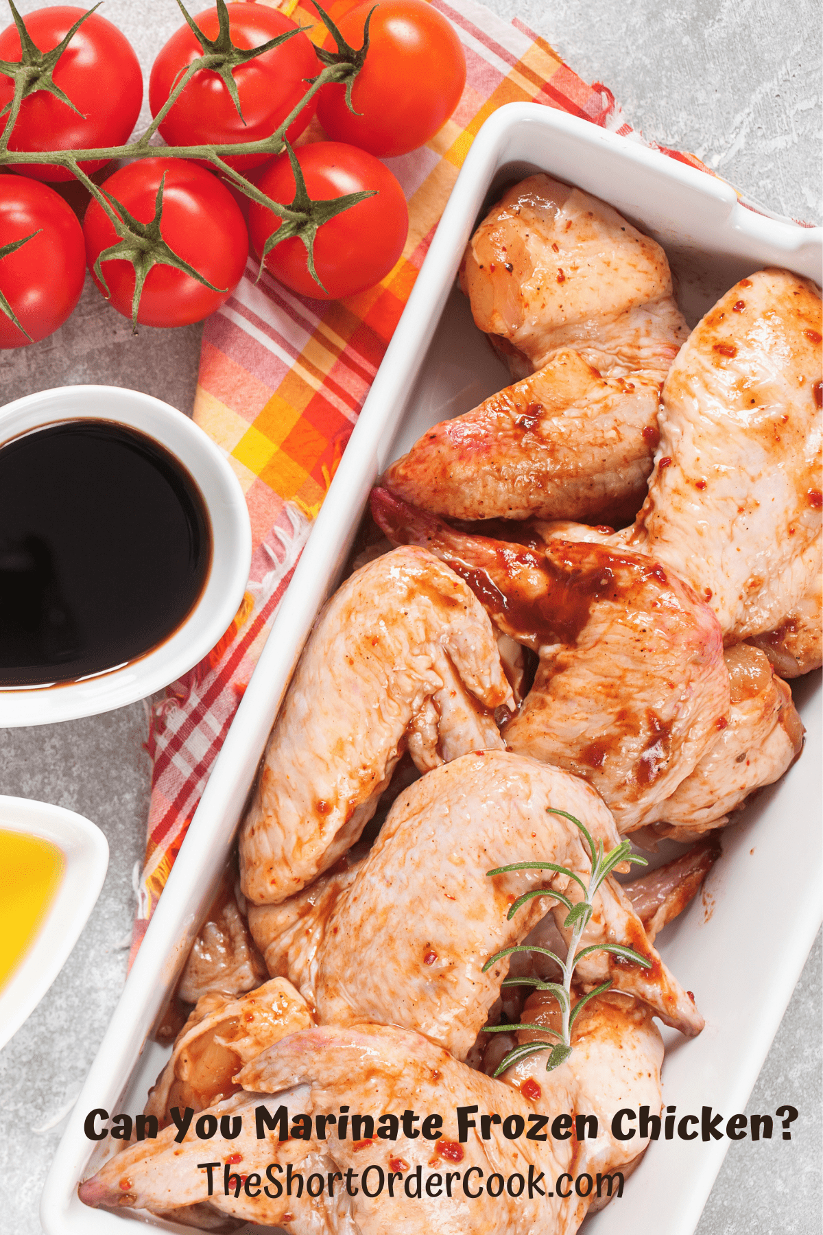 Chicken wings in a dish with marinade ingredients in bowls next to it.