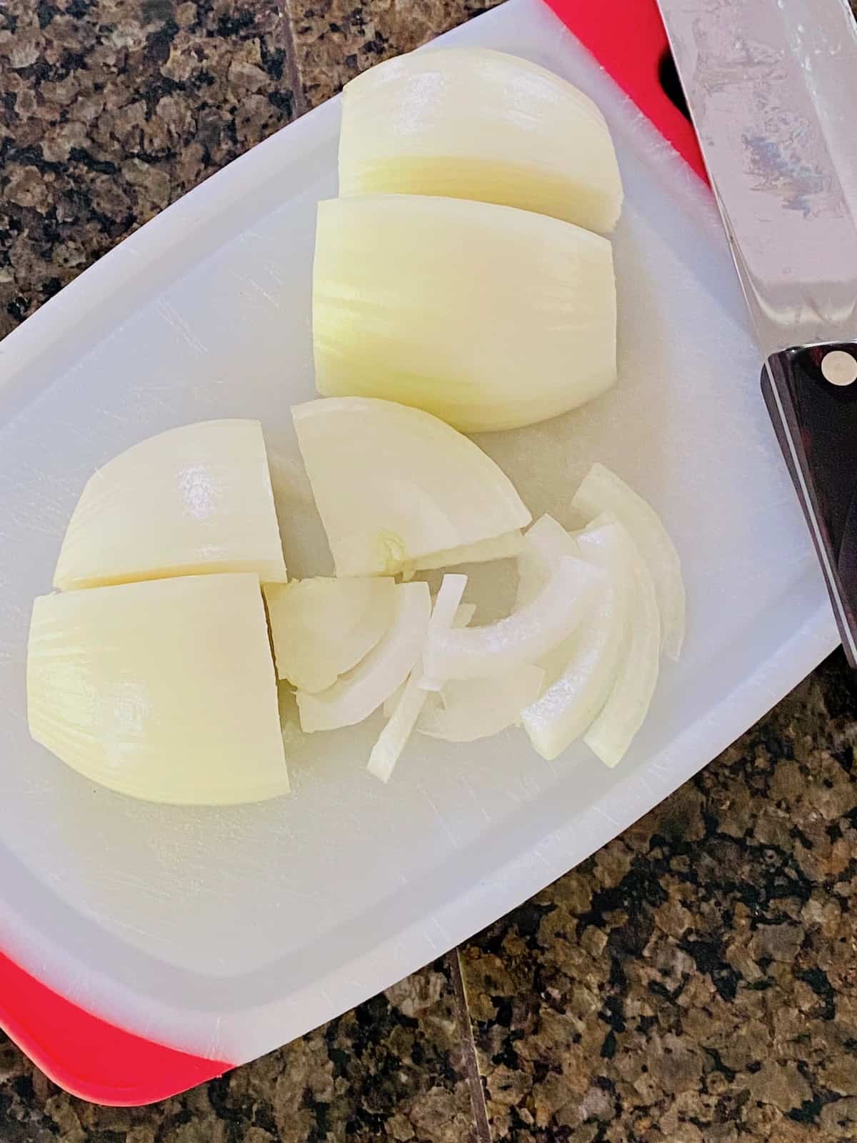 Onion cut into 4 pieces and then thinly sliced.