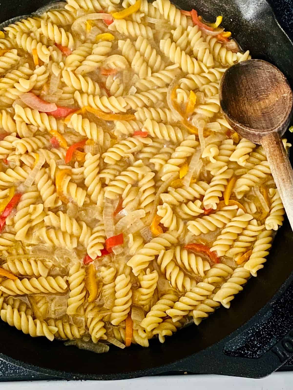 Pasta is cooked and a bit of liquid still in the pan.