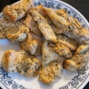 Plated pieces of air fryer chicken pieces.