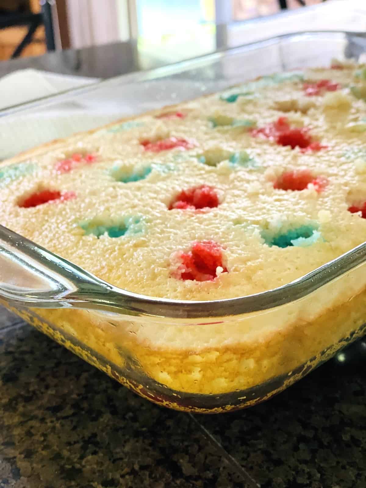 All the holes of the white caked filled with the red or blue Jello.